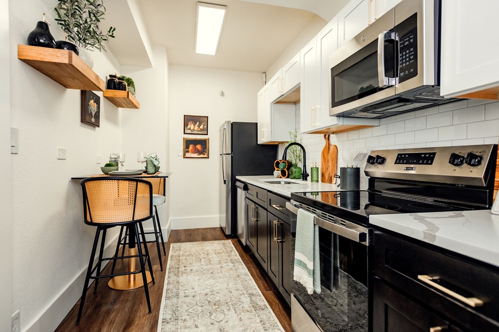 A kitchen with black appliances and white cabinets. at Parkview Apartments, Memphis, TN