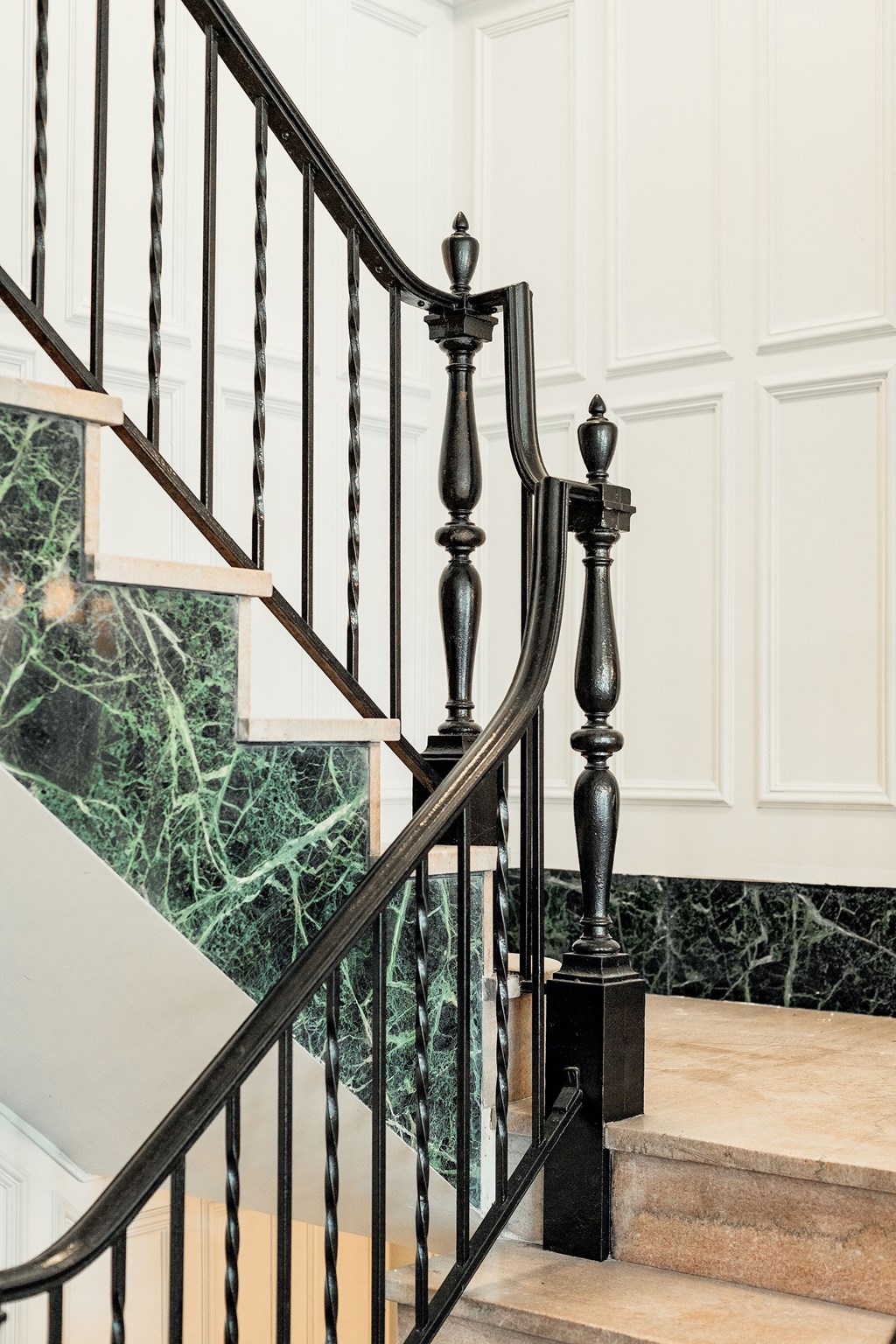A staircase with a black railing and a green marble wall. at Parkview Apartments, Memphis, 38104