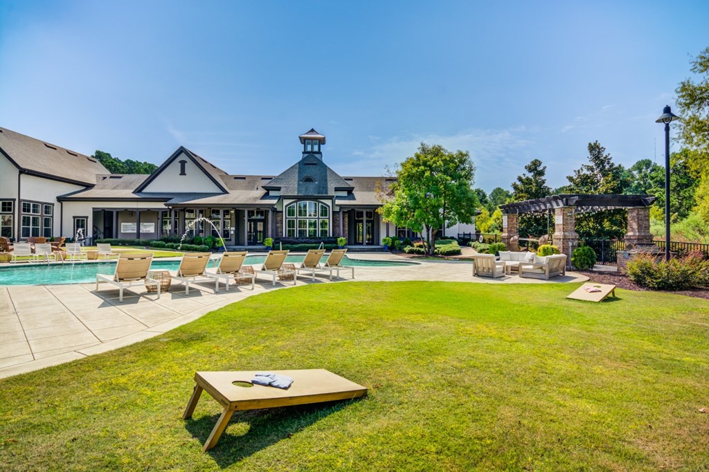 A large building with a pool in front of it.