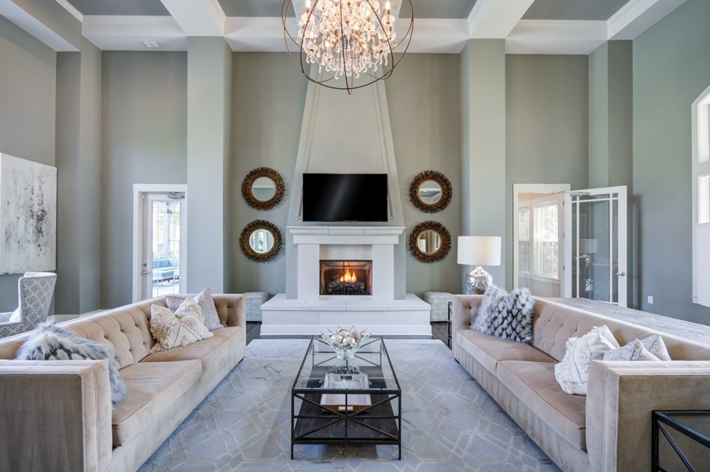 A living room with a fireplace and a chandelier.