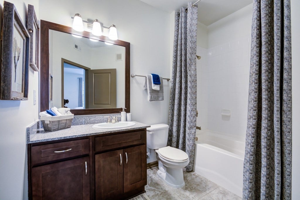 A bathroom with a white toilet and a white sink.