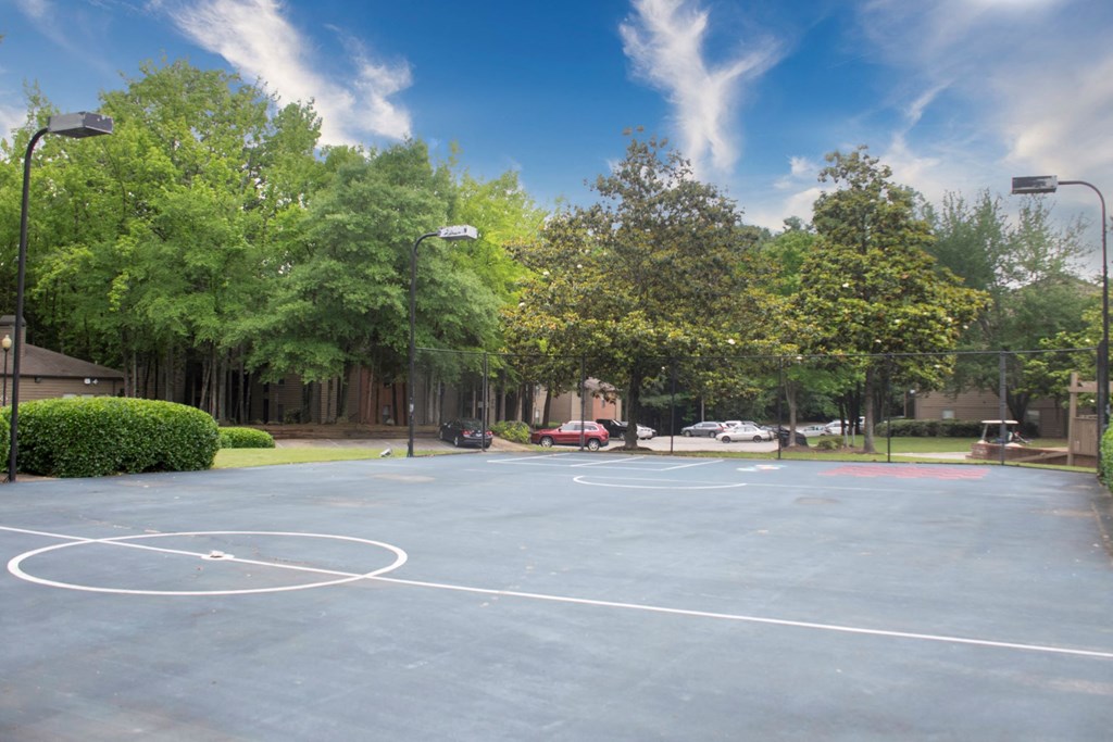 a basketball court in a park with trees at The Summit Apartments, Tennessee