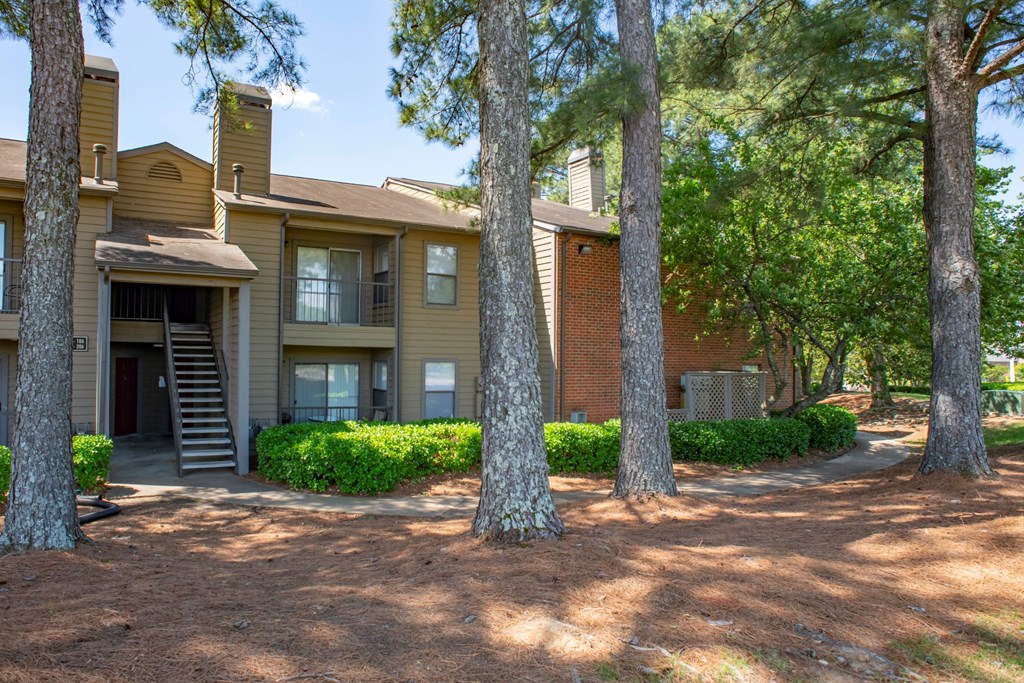 exterior view of the apartments with trees and a pathway at The Summit Apartments, Tennessee
