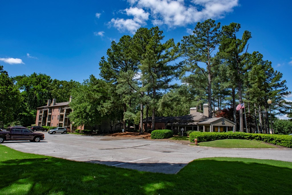 a view of a building with trees and a parking lot at The Summit Apartments, Memphis, TN, 38128