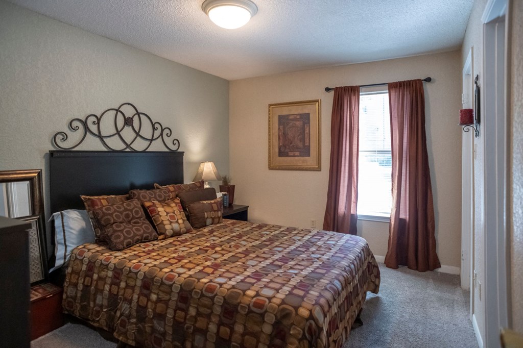 a bedroom with a bed and a window at The Summit Apartments, Memphis, Tennessee