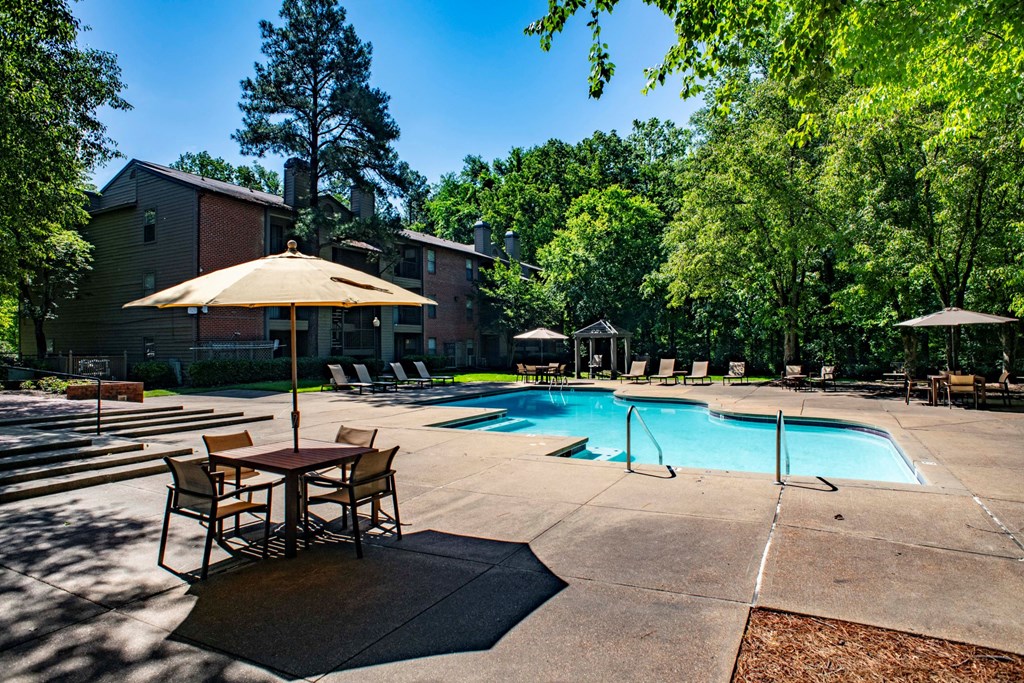 our apartments offer a swimming pool with tables and umbrellas at The Summit Apartments, Memphis, 38128