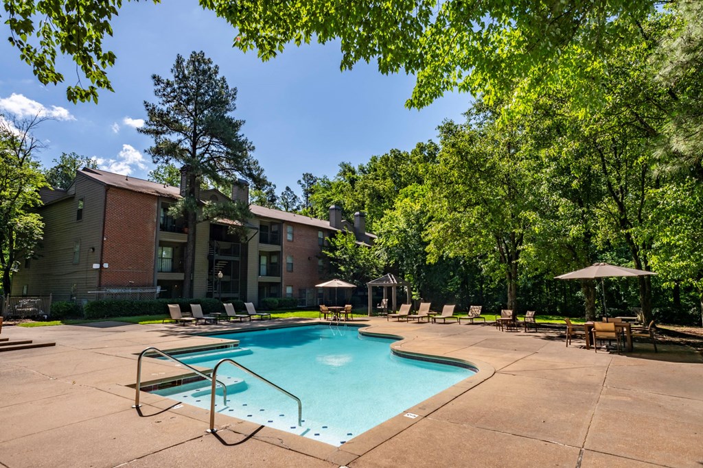 our apartments offer a swimming pool with chairs and trees at The Summit Apartments, Memphis, 38128