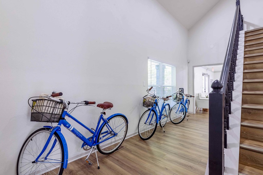 three bikes are lined up against a wall in a room with stairs at The Waters at Chenal, Arkansas, 72211
