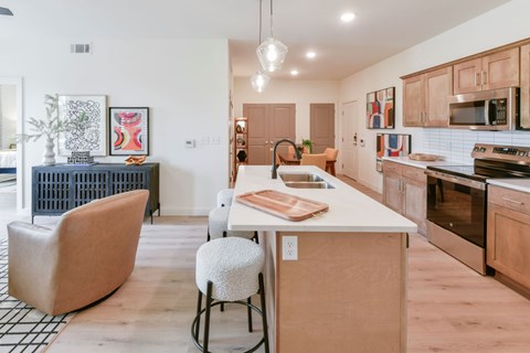 A kitchen with a white counter top and wooden cabinets.