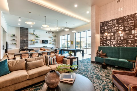 A living room with a green couch and a coffee table.
