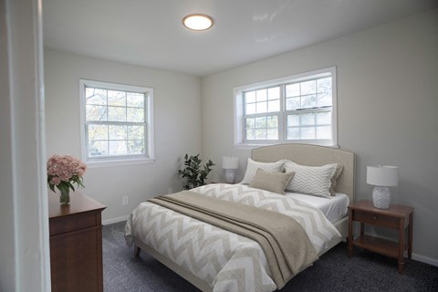 a bedroom with a bed and two windows  at Venue at Carrollton, Georgia