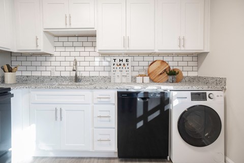 a white kitchen with white cabinets and a washing machine  at Venue at Carrollton, Georgia