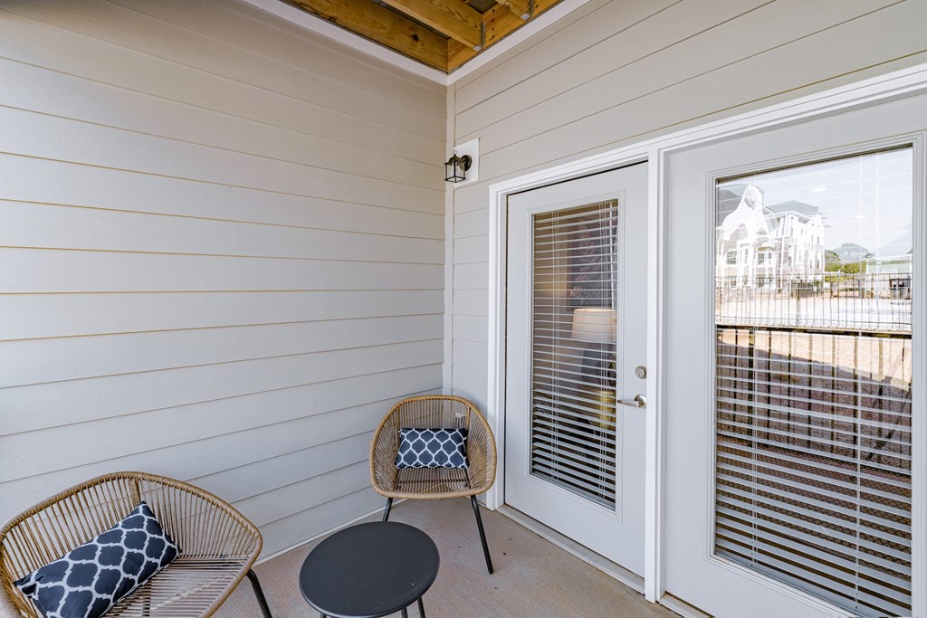 A patio with a chair and a table. at The One at Spartanburg, South Carolina, 29303