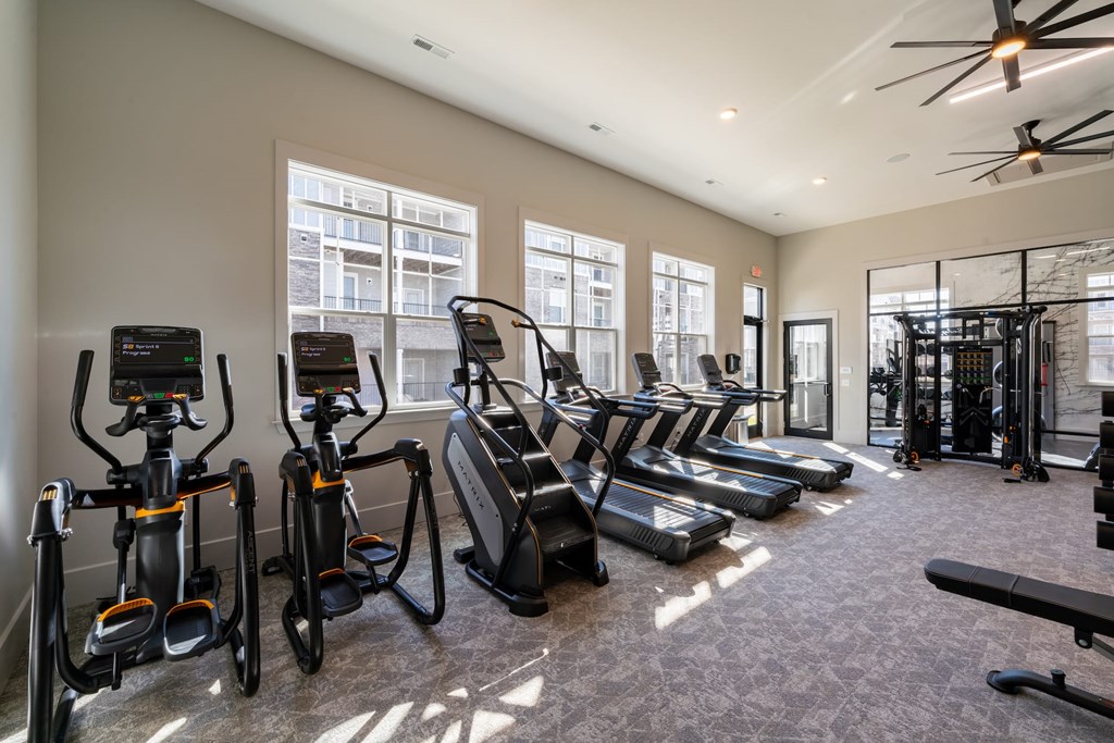A gym with treadmills, elliptical machines, and stationary bikes. at The One at Spartanburg, Spartanburg, South Carolina