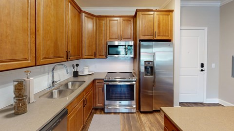 A kitchen with wooden cabinets and stainless steel appliances.