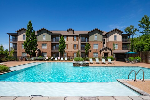 A large apartment complex with a swimming pool in front. at Hall Creek Apartment Homes, Tennessee, 38002