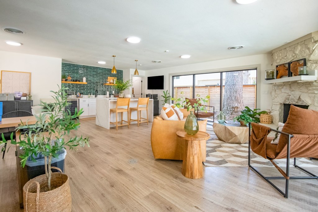 A living room with a fireplace and a dining table.