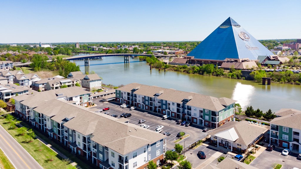 an aerial view of apartment buildings with the pyramids in the background at Grand Island Apartments in Memphis TN 38103