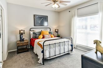 Secondary bedroom with ceiling fan and large window at Grand Island Apartments in Memphis TN 38103