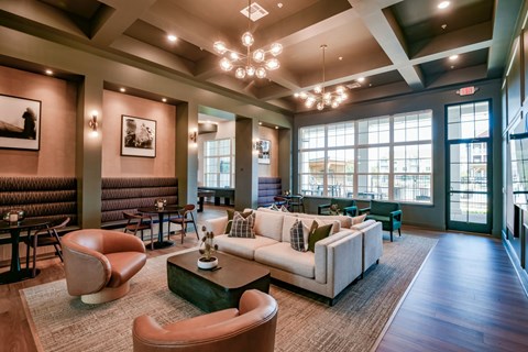 A living room with a brown leather chair and a white couch.