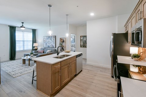 A modern kitchen with wooden cabinets and a large island.