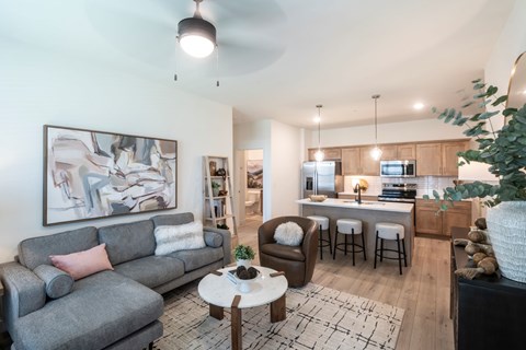 A living room with a grey couch and a coffee table.