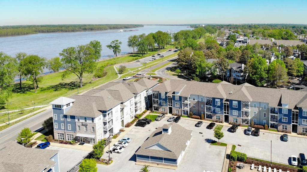 an aerial view of a large apartment complex with a river in the background