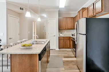 Kitchen with Stainless Steel Appliances and Wood Cabinets at Harbor Island located in Memphis, TN 38103 - Photo Gallery 3