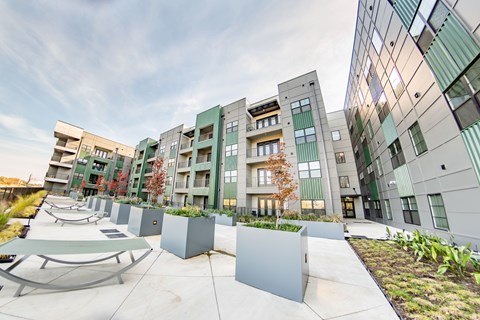 A modern building complex with a playground in the foreground at Conwood Flats Apartments, Memphis, TN