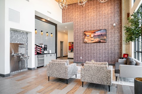 A modern living room with a grey sofa and a television on the wall at Conwood Flats Apartments, Memphis, 38107