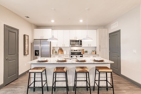 a kitchen with a marble counter top and bar stools