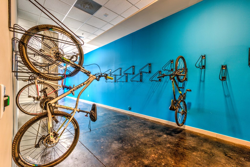 A room with a blue wall and a bicycle hanging on the wall at Highland Row Apartments, Tennessee, 38111