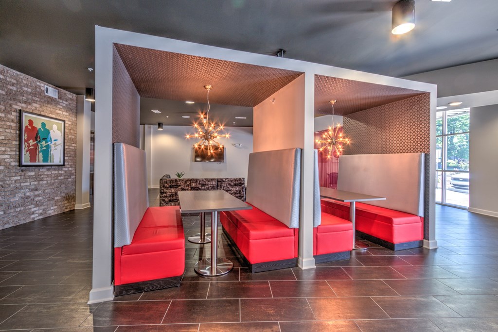 A room with a table and chairs with a red cushion at Highland Row Apartments, Memphis