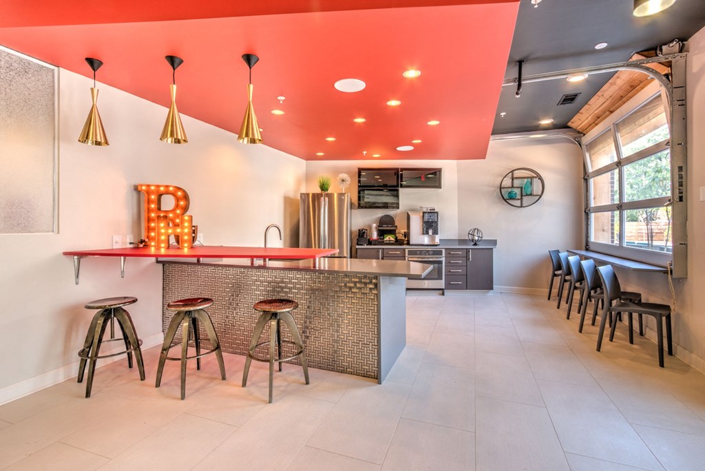 A bar area with a counter and stools at Highland Row Apartments, Memphis, Tennessee