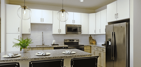 a kitchen with granite counter tops and stainless steel appliances