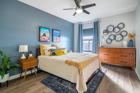 A bedroom with a bed, nightstand, and a ceiling fan.at Iris Luxury Apartments, Tennessee, 38105