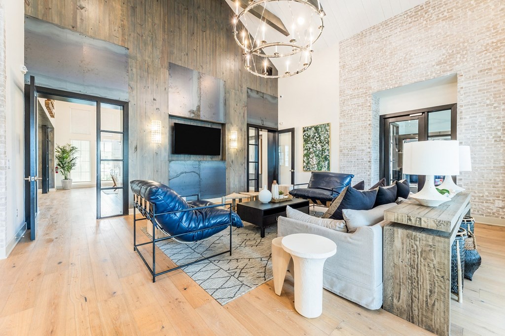 a living room filled with furniture and a large chandelier at The Livano Kemah, Texas