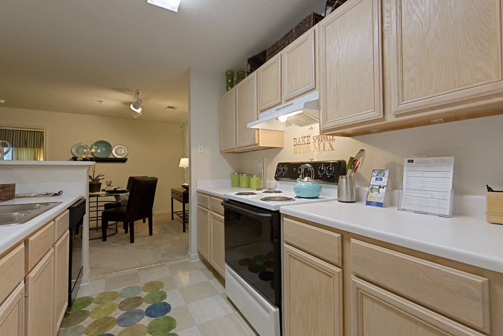 a kitchen with light wood cabinets and a checkered floor at Lake Cameron, Apex, North Carolina