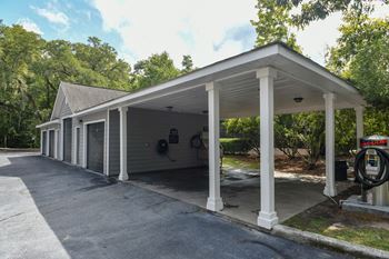 the front of a car dealership with a covered parking lot