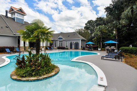 A pool with a small island in the middle of it.