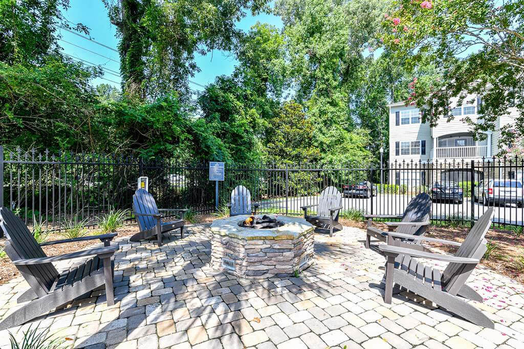 Lounge chairs around fire pit at Legends at Charleston Park Apartments, North Charleston, SC, 29420