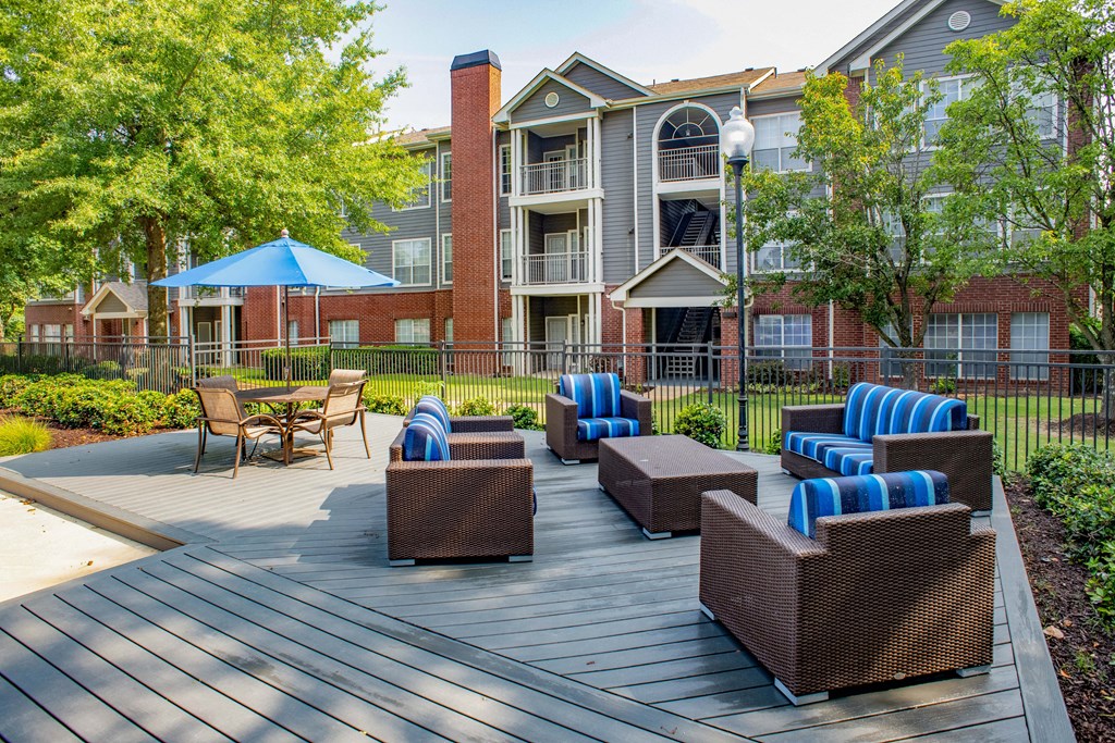 our apartments showcase a large deck with lounge chairs and a fire pit at Lincoln at Wolfchase, Cordova Tennessee