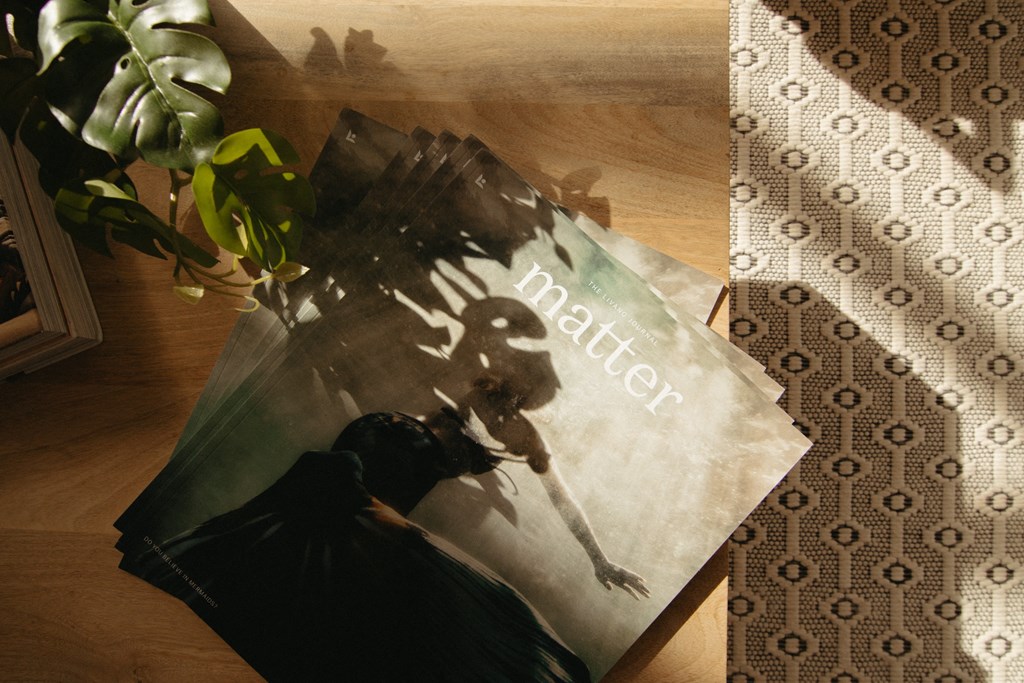 a book sitting on a table next to a plant
