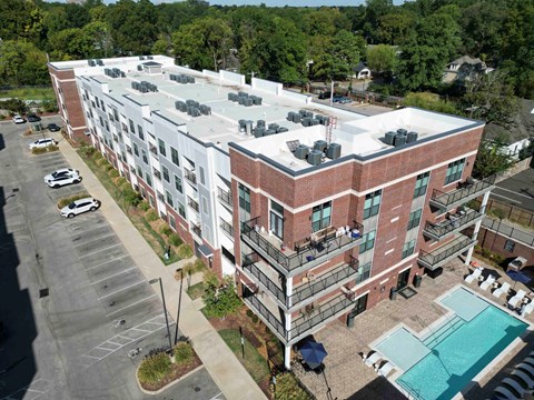Aerial view of apartment building with pool and parking at Madison Midtown Apartments, Memphis, NY