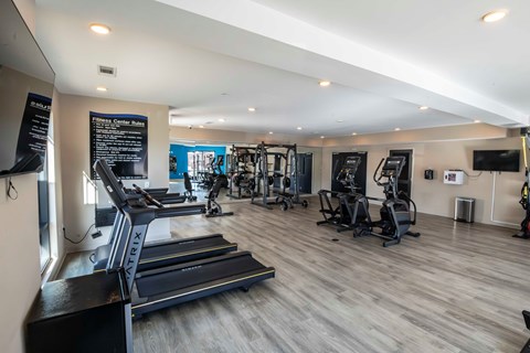 Fitness center with cardio and strength equipment at Madison Midtown Apartments, Memphis, NY