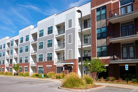 A row of modern apartment buildings with balconies and windows.