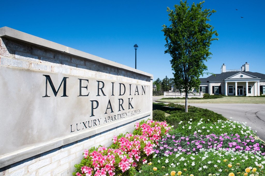 a sign that says meridian park with flowers in front of it,  at Meridian Park Apartments, Collierville, Tennessee