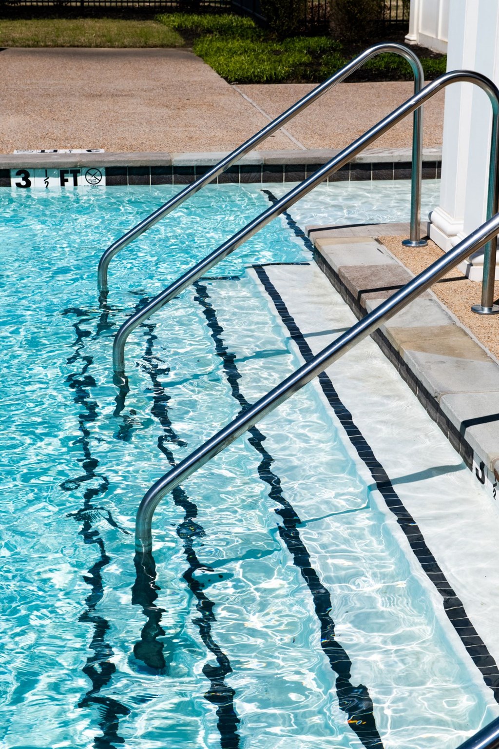 a swimming pool with stainless steel handrails at Meridian Park in Collierville, TN 38017