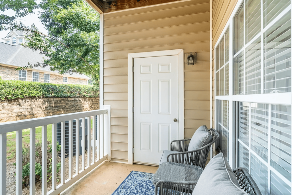 A white door is on the side of a house at Henley at Mirror Lake Apartments, Villa Rica, GA, 30180