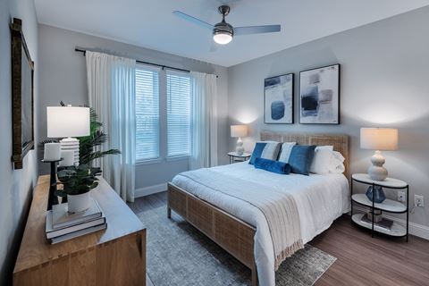 a bedroom with a large bed and a large window at The Livano Kemah, Kemah